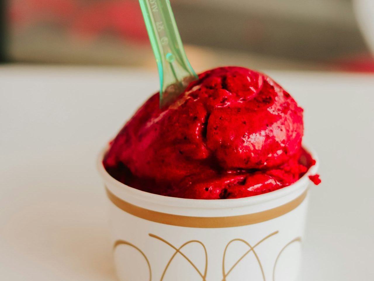 a cup of ice cream with a spoon in it